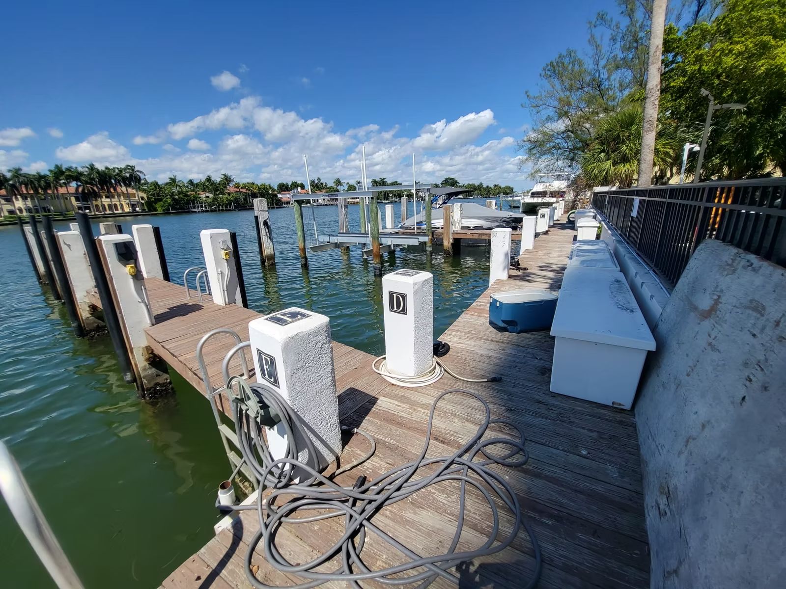 Condominium marina dock with power pedestals, pilings and a seawall