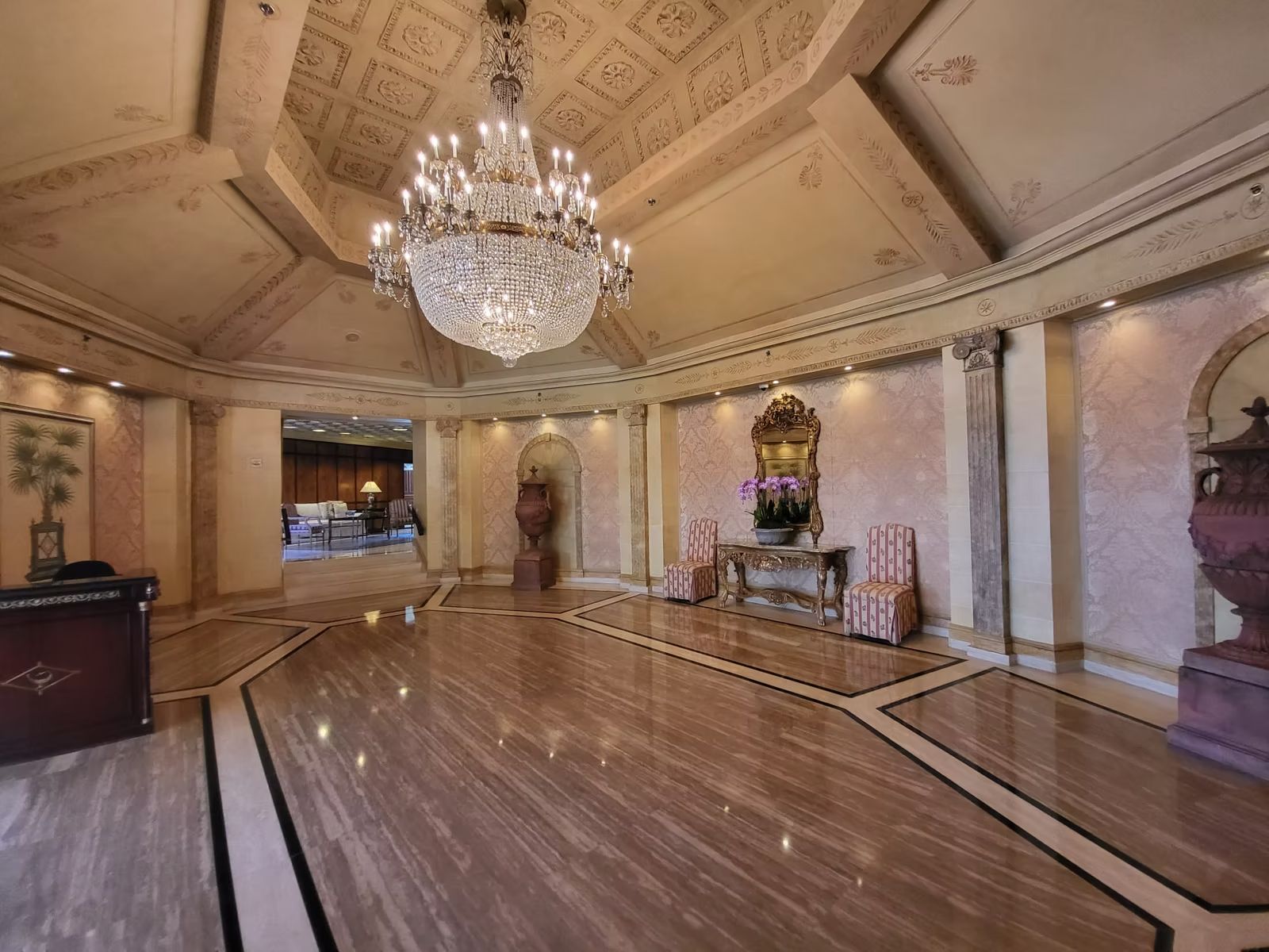 Grand condominium lobby with crystal chandelier and inlaid wood floor