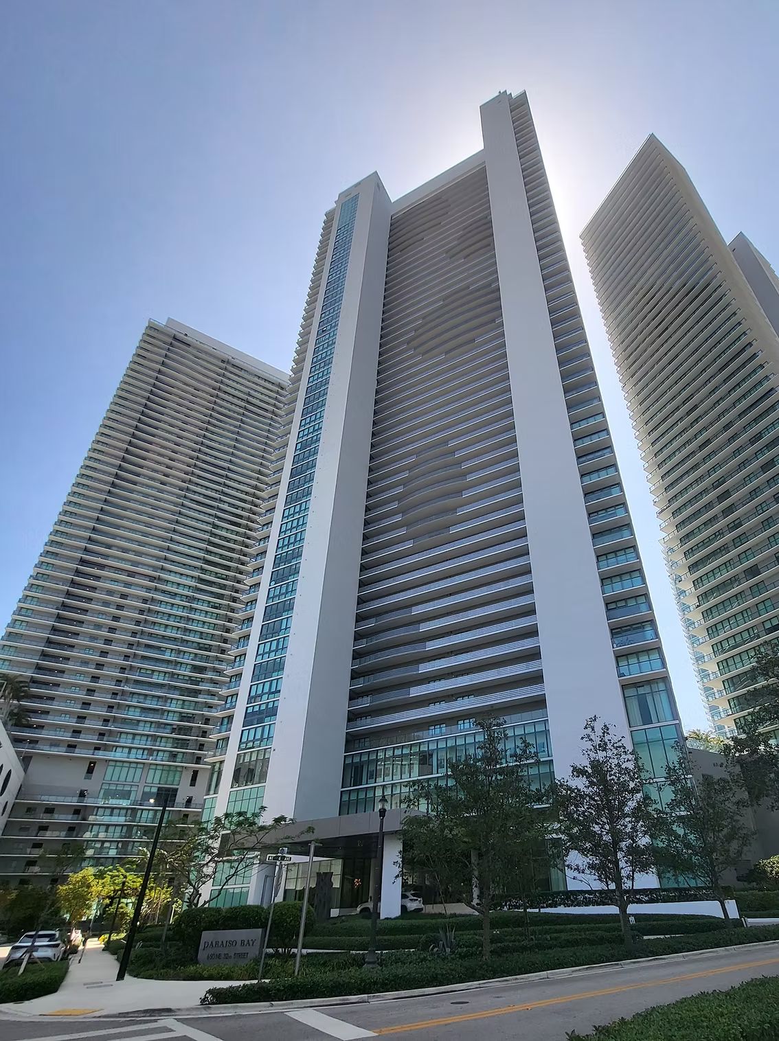 Twin glass high-rise condominium towers seen from street level